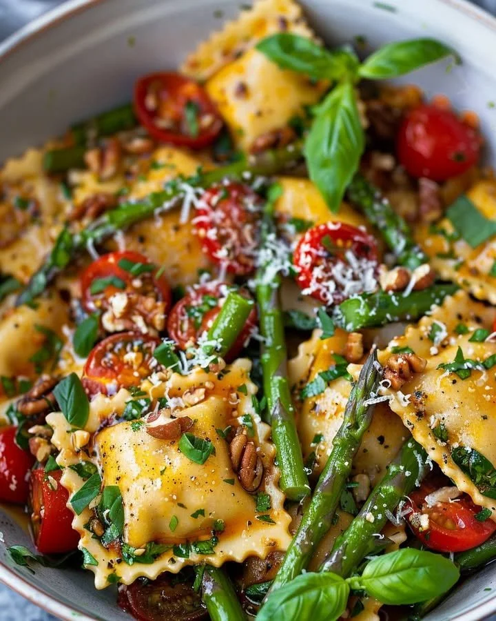 Bowl of garden fresh asparagus and tomato ravioli with vibrant colors