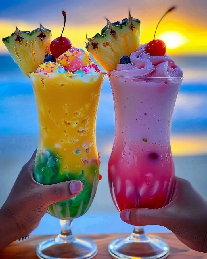 Colorful Rainbow Sherbet Piña Colada in a tropical glass with fruit garnishes