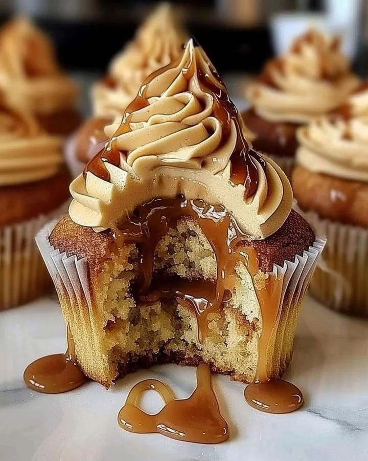 Delicious Salted Caramel Cupcakes topped with creamy frosting and caramel drizzle