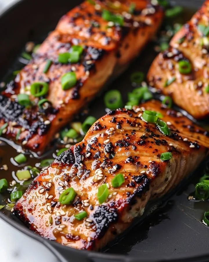 Plate of silken miso-ginger glazed salmon garnished with herbs