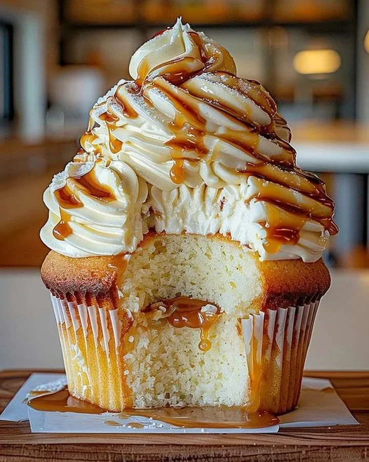 Delicious caramel cupcake with cream cheese frosting on a decorative plate