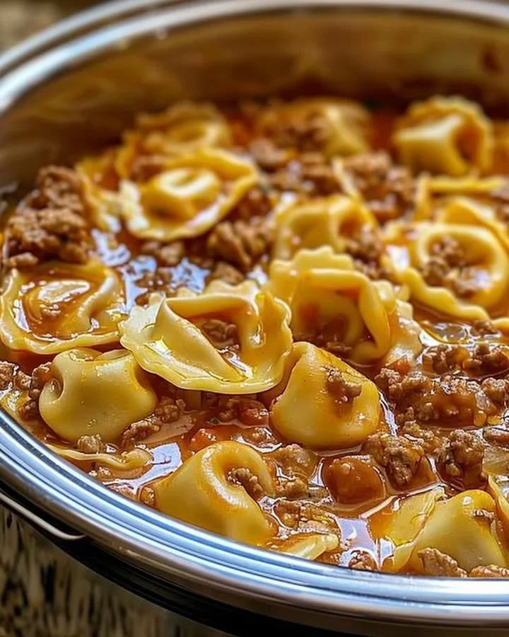Slow cooker cheesy tortellini with melted cheese and herbs