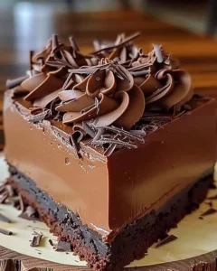 Decadent chocolate mousse cake topped with whipped cream and chocolate shavings