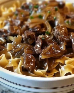 Delicious bowl of French Onion Beef Noodles topped with melted cheese
