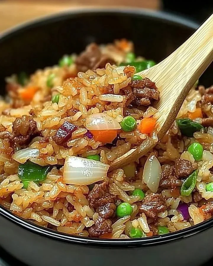 Heroic Onion Beef Fried Rice served in a bowl with fresh ingredients.