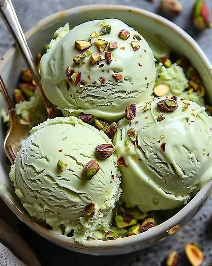 Protein-rich pistachio ice cream in a bowl with chopped nuts